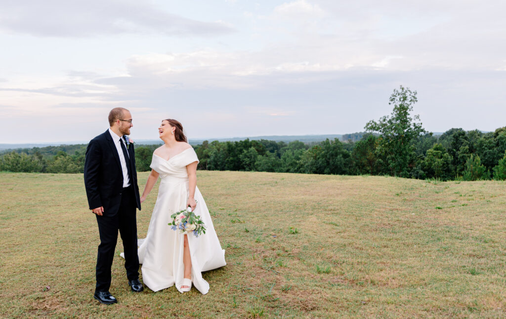 A bride and groom sharing a candid moment during golden hour.