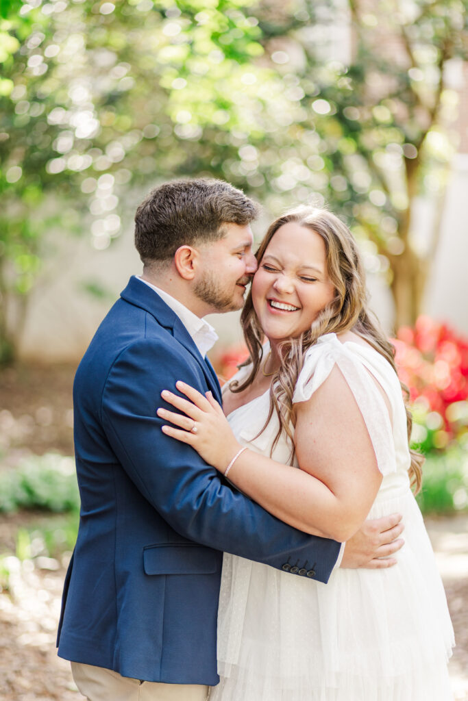 Couple laughing during engagement session in Tuscaloosa.