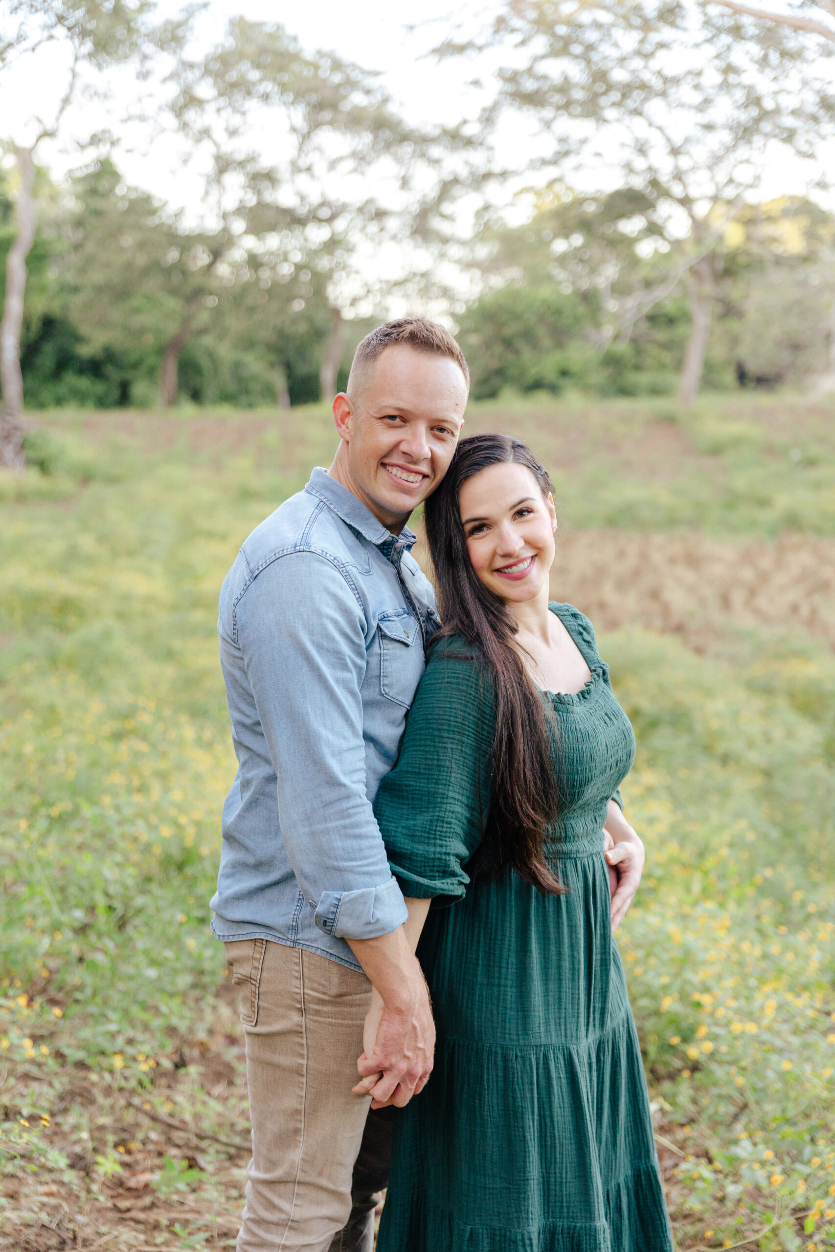 Couple holding hands and looking at the camera smiling