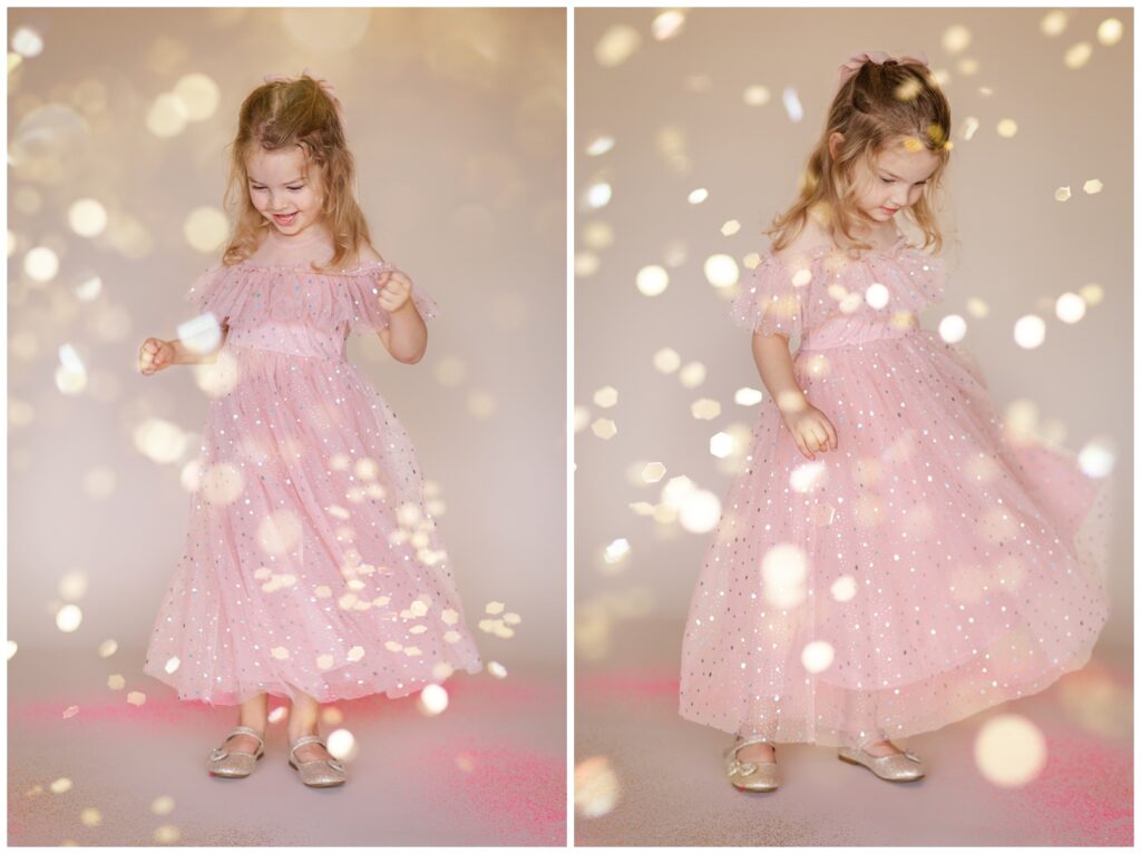 Little girl in a pink dress twirling and smiling as glitter falls down in a glitter photoshoot