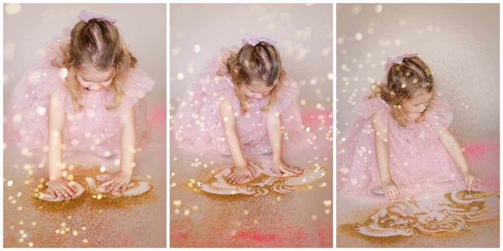 Little girl in a pink dress playing in glitter on the floor for a glitter photoshoot