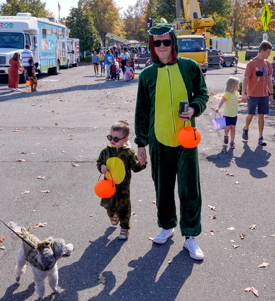 A father and son dressed up as dinosaurs for Boo! in the Park in Tuscaloosa, Alabama.