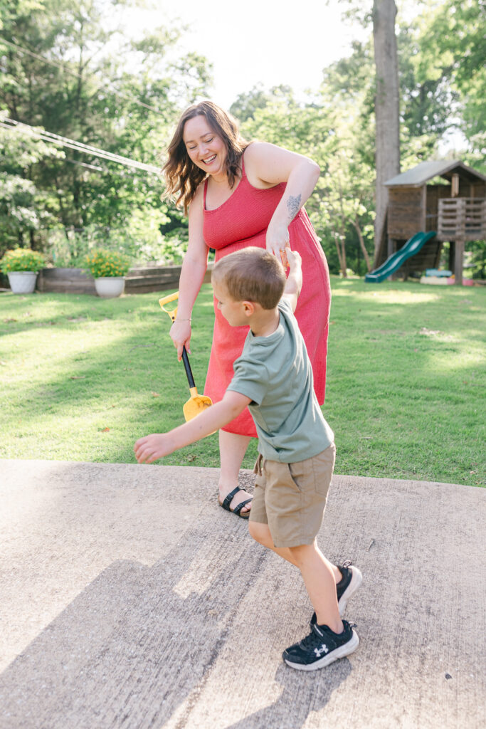 Mother and son playing together during a documentary summer family session near Tuscaloosa.