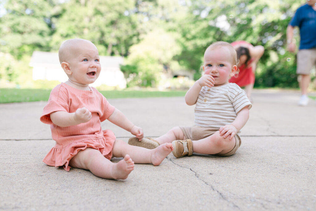 Two little ones during a summer family session in Tuscaloosa, captured at their own eye level.