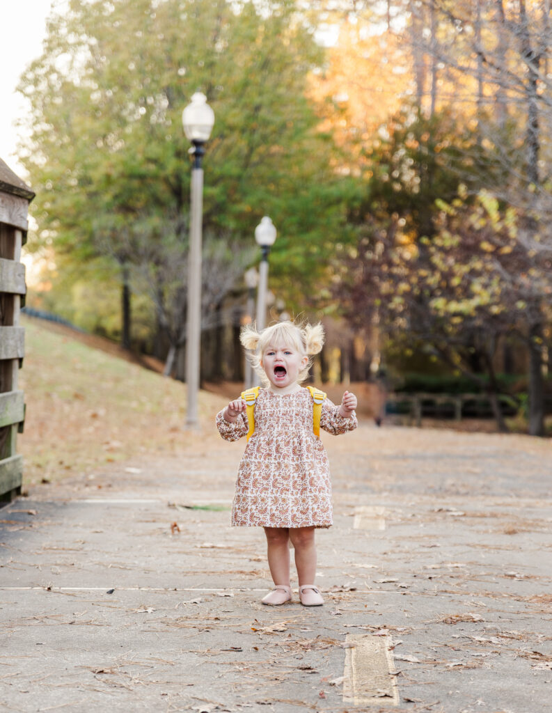 Relaxed family photographer in Tuscaloosa capturing a toddler's real, unposed expression during a family session