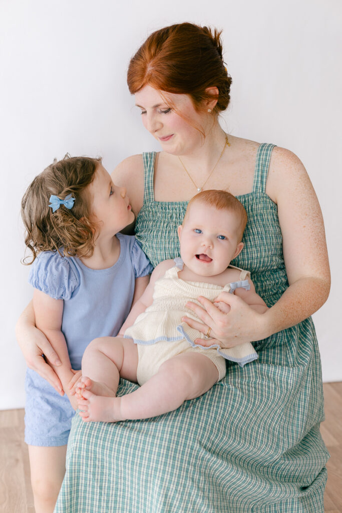Mom and her daughters cuddled together during a Mommy and Me studio session in Tuscaloosa, Alabama